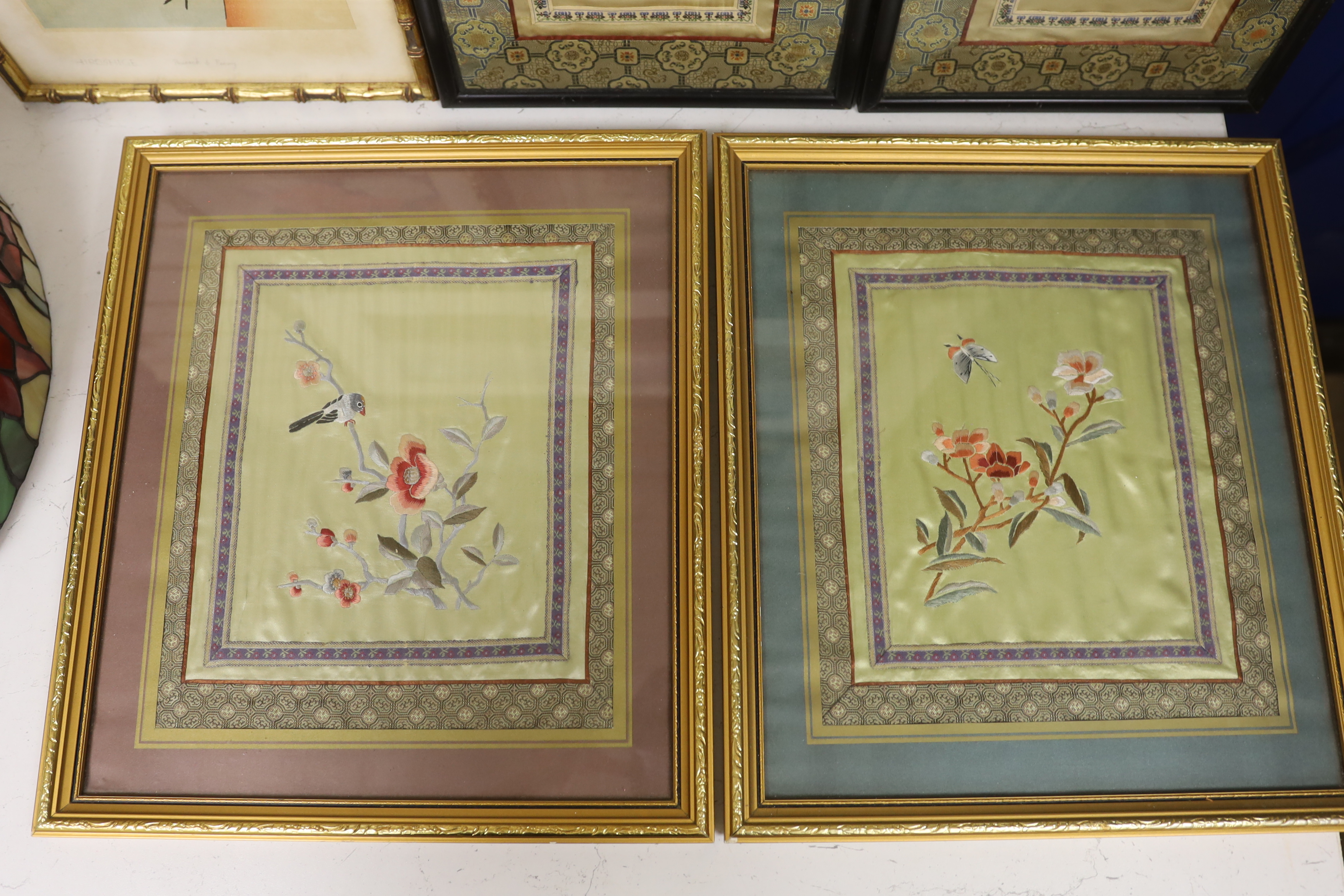 Two pairs of framed 20th century Chinese silk embroideries, two using Chinese knotting, a Hiroshima ‘Peacock and Peony’ print and a circular, figural landscape embroidery (6)